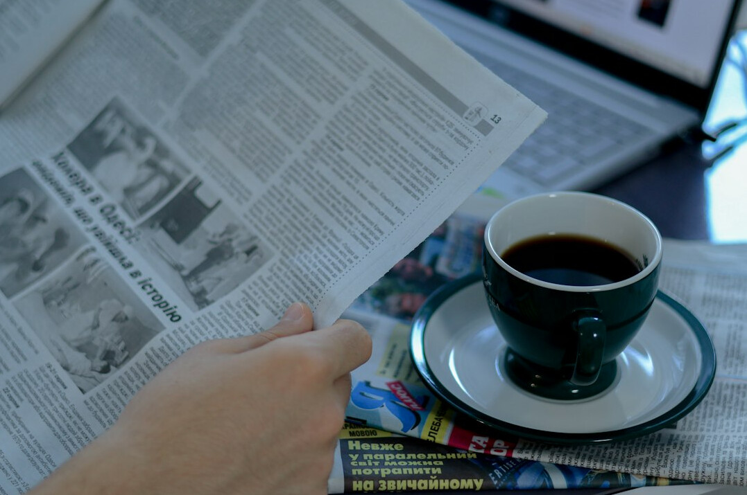 person reading newspaper