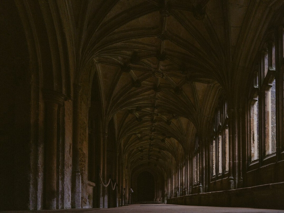 Dark empty museum corridor with soft overhead lighting